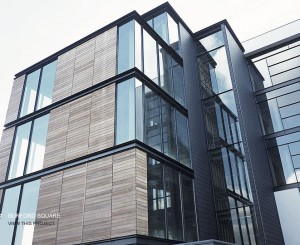 Building envelope that includes masonry and glass curtain wall systems